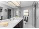 Bathroom with updated vanity, glass door shower, and neutral grey walls at 18584 Alphonse Cir, Port Charlotte, FL 33948