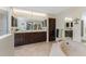 Bathroom featuring dual vanities, a large mirror, and a corner soaking tub at 18584 Alphonse Cir, Port Charlotte, FL 33948