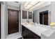 Bathroom with dark wood cabinets and a large mirror over the vanity at 18584 Alphonse Cir, Port Charlotte, FL 33948