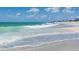 Picturesque beach scene featuring sparkling turquoise waves, white sand, and beachgoers enjoying the sunshine at 18584 Alphonse Cir, Port Charlotte, FL 33948