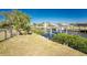 View of the canal featuring well-maintained landscaping, and a boat lift, enhancing the waterfront lifestyle at 18584 Alphonse Cir, Port Charlotte, FL 33948