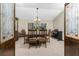 Traditional dining room featuring an elegant chandelier and a dark wood dining table with six chairs at 18584 Alphonse Cir, Port Charlotte, FL 33948