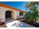 Screened doorway entrance framed by lush tropical landscaping at 18584 Alphonse Cir, Port Charlotte, FL 33948