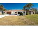Charming single-story home featuring a stucco exterior, arched entryways, and a well-maintained lawn at 18584 Alphonse Cir, Port Charlotte, FL 33948