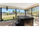 Relax in the enclosed lanai featuring a luxurious hot tub and views of the landscaped backyard at 18584 Alphonse Cir, Port Charlotte, FL 33948