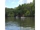 People kayaking along calm river surrounded by lush, green trees, ideal for outdoor adventures and nature exploration at 18584 Alphonse Cir, Port Charlotte, FL 33948