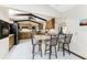 Eat-in kitchen features a breakfast bar, tile floors, wooden cabinets, granite countertops and stainless-steel appliances at 18584 Alphonse Cir, Port Charlotte, FL 33948