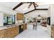 Eat-in kitchen boasts wood cabinets, granite countertops, stainless-steel appliances, and tiled flooring at 18584 Alphonse Cir, Port Charlotte, FL 33948