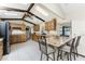 Well-lit kitchen with granite countertops, wooden cabinets, stainless steel appliances, and barstool seating at 18584 Alphonse Cir, Port Charlotte, FL 33948