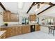 The well-equipped kitchen features wood cabinets, granite countertops, stainless-steel appliances, and tiled flooring at 18584 Alphonse Cir, Port Charlotte, FL 33948