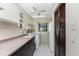 Bright laundry room featuring sink, washer, dryer, cabinets, and refrigerator at 18584 Alphonse Cir, Port Charlotte, FL 33948