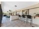 Enclosed patio with tile flooring, ceiling fans, bar seating, and access to an outdoor seating area with a jacuzzi at 18584 Alphonse Cir, Port Charlotte, FL 33948