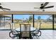 Enjoy outdoor dining in the screened patio with views of the backyard and canal at 18584 Alphonse Cir, Port Charlotte, FL 33948