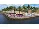 Colorful waterfront restaurant exterior, with palm trees, thatched roofs, and brightly colored Adirondack chairs at 18584 Alphonse Cir, Port Charlotte, FL 33948
