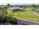 Beautiful aerial view of the home, screened-in pool, and lush waterfront property at 19023 Midway Blvd, Port Charlotte, FL 33948