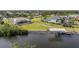 Expansive waterfront property featuring a home with screened pool, boat dock, and manicured landscaping at 19023 Midway Blvd, Port Charlotte, FL 33948
