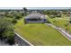 An aerial view showcases a home with a screened pool, extensive yard, and waterfront access at 19023 Midway Blvd, Port Charlotte, FL 33948