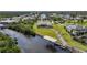 Stunning aerial view of a waterfront home featuring a private boat dock, lush landscaping, and serene canal access at 19023 Midway Blvd, Port Charlotte, FL 33948