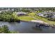 Beautiful waterfront property with lush landscaping, private dock, and ample green space, perfect for enjoying the Florida lifestyle at 19023 Midway Blvd, Port Charlotte, FL 33948