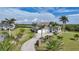 Aerial view showcasing the home's curb appeal, manicured lawn, and driveway at 19023 Midway Blvd, Port Charlotte, FL 33948