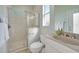 Clean bathroom featuring a glass-enclosed shower, light-colored tiles, and a white vanity with modern fixtures at 19023 Midway Blvd, Port Charlotte, FL 33948