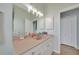 Bathroom featuring light cabinets, double closets, tile floor, and a large mirror at 19023 Midway Blvd, Port Charlotte, FL 33948