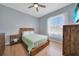 Bedroom featuring hard wood floors, a large window, and a wooden bed frame at 19023 Midway Blvd, Port Charlotte, FL 33948