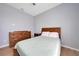 Cozy bedroom features a wooden headboard, dresser, and light green comforter, offering a relaxing retreat at 19023 Midway Blvd, Port Charlotte, FL 33948