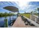 Private boat dock with lift, offering direct access to the water and stunning views of the property at 19023 Midway Blvd, Port Charlotte, FL 33948