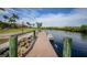 Waterfront property featuring a private boat dock, lush landscaping, and stunning views of the canal at 19023 Midway Blvd, Port Charlotte, FL 33948