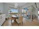 Bright dining area with a modern chandelier, natural light, and access to an outdoor space at 19023 Midway Blvd, Port Charlotte, FL 33948