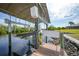 A private dock with a covered boat lift, offering direct access to the waterfront at 19023 Midway Blvd, Port Charlotte, FL 33948