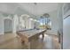 Bright game room featuring a pool table, stylish lighting, and beautiful flooring at 19023 Midway Blvd, Port Charlotte, FL 33948