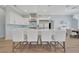 Stylish kitchen featuring white cabinets, a spacious island with seating, and stainless steel appliances at 19023 Midway Blvd, Port Charlotte, FL 33948