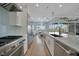 Well-equipped kitchen with a large island, stainless steel appliances, and a view of the outdoor pool at 19023 Midway Blvd, Port Charlotte, FL 33948