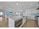 Open concept kitchen with a large island, modern appliances, and seamless flow to living area at 19023 Midway Blvd, Port Charlotte, FL 33948
