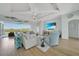 Bright living room with light wood floors, comfortable seating, and access to an outdoor area at 19023 Midway Blvd, Port Charlotte, FL 33948