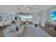 Open-concept living room with a comfortable sectional sofa, stylish decor, and plenty of space at 19023 Midway Blvd, Port Charlotte, FL 33948