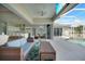 Relaxing outdoor patio with wicker furniture, kitchen access, and a view of the sparkling pool and tropical landscape at 19023 Midway Blvd, Port Charlotte, FL 33948