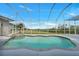 Enclosed pool area with a spa and spacious deck, perfect for outdoor relaxation and entertainment at 19023 Midway Blvd, Port Charlotte, FL 33948