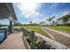Lush waterfront property with a private boat dock, manicured lawn, and paver path leading to the house at 19023 Midway Blvd, Port Charlotte, FL 33948