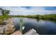 Picturesque waterfront view from the dock, offering serene water and tropical greenery at 19023 Midway Blvd, Port Charlotte, FL 33948