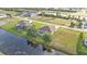 Expansive aerial view of a home in a waterfront community with lush greenery and beautiful water views at 235 Tournament Rd, Rotonda West, FL 33947