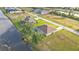 Aerial view of home featuring a screened-in pool in a waterfront community at 235 Tournament Rd, Rotonda West, FL 33947