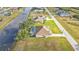 Aerial view of home featuring a screened-in pool in a waterfront community at 235 Tournament Rd, Rotonda West, FL 33947