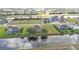 Expansive aerial view of a home in a waterfront community with lush greenery and beautiful water views at 235 Tournament Rd, Rotonda West, FL 33947