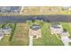Bird's-eye view displays the property, featuring a pool and its location on a waterfront lot in a residential neighborhood at 235 Tournament Rd, Rotonda West, FL 33947