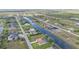 This aerial view displays homes along a waterway, demonstrating the community's design and access to water views at 235 Tournament Rd, Rotonda West, FL 33947