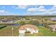 Aerial view of a well-maintained single-Gathering home with mature landscaping and a water view at 235 Tournament Rd, Rotonda West, FL 33947