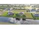 Expansive aerial view of a home in a waterfront community with lush greenery and beautiful water views at 235 Tournament Rd, Rotonda West, FL 33947